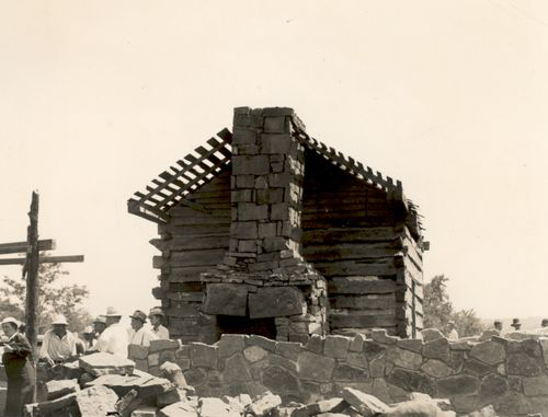 Building a protective structure around the cabin, ca. 1936 (Oklahoma Historical Society Photograph Collection) Courtesy of the Oklahoma Historical Society